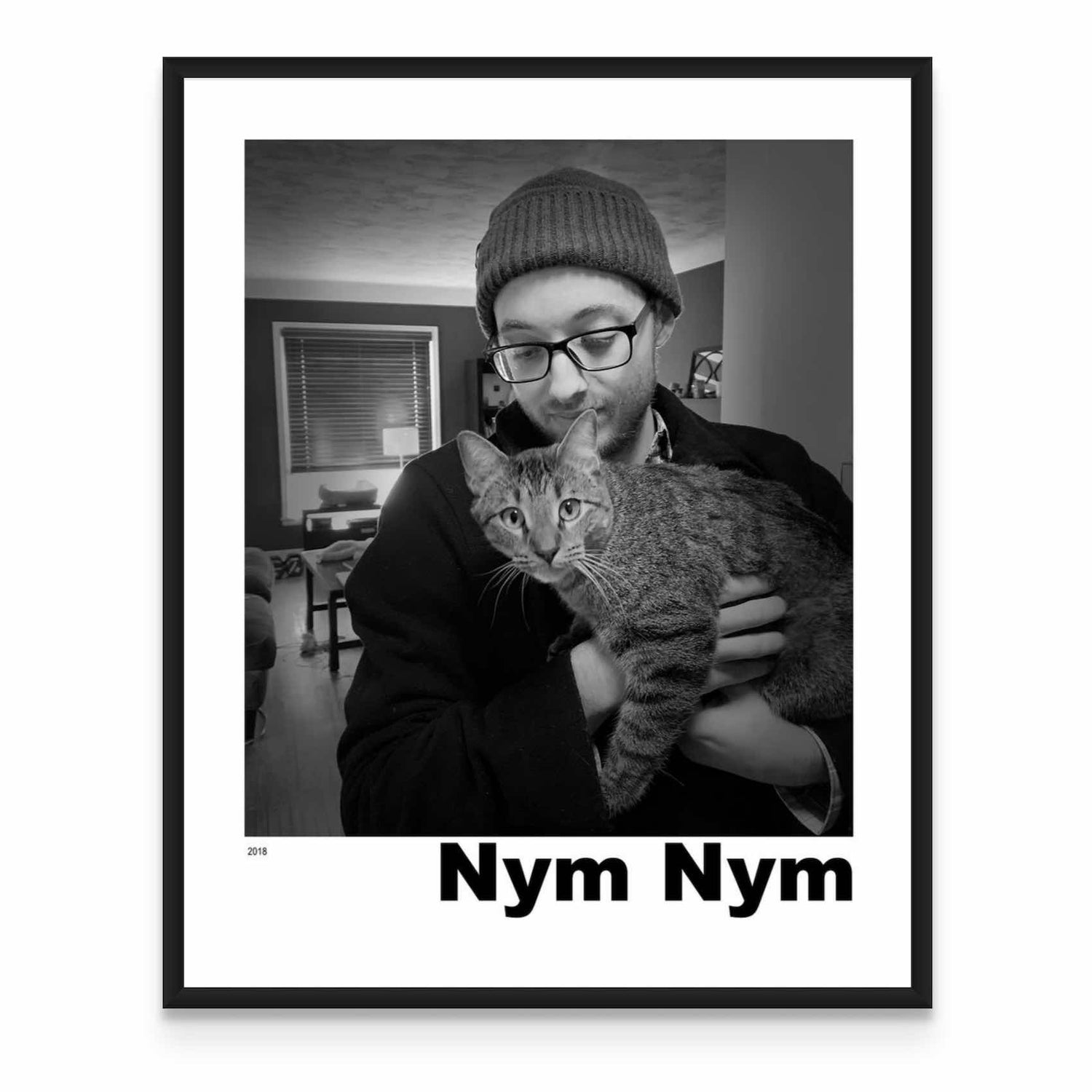 a black and white photo of a man holding a cat